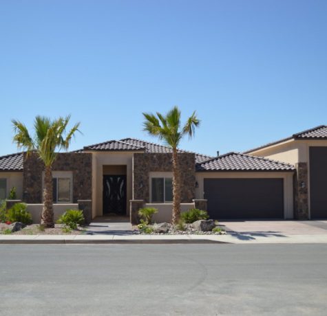 Tiled roofed home installed by stout roofing with palm trees in front yard.