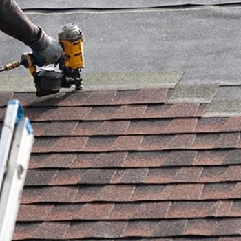 Stout roofing installing new shingles on roof.