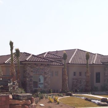 Tiled roof single story home with carriage in front yard.
