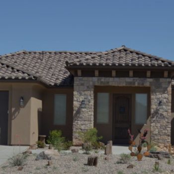 Tiled roof on home with desert landscape.